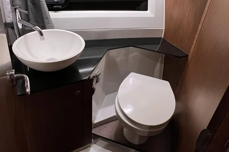  Yacht Photos Pics Modern bathroom in 2021 Jeanneau NC 1095 FLY boat with sink and toilet.