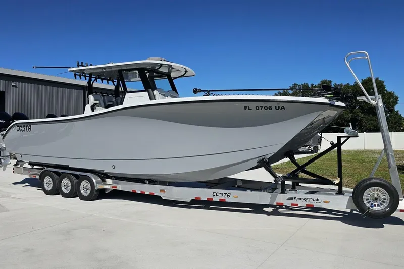  Yacht Photos Pics 2025 Costa Custom Boats 34ST on trailer, sleek design, parked outdoors under clear blue sky.