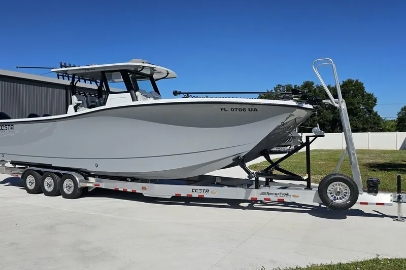 Yacht Photos Pics 2025 Costa Custom Boats 34ST on trailer, parked outdoors under clear blue sky.