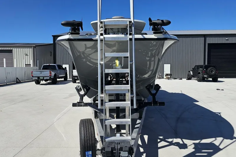  Yacht Photos Pics 2025 Costa Custom Boats 34ST on trailer, parked in industrial area under clear blue sky.