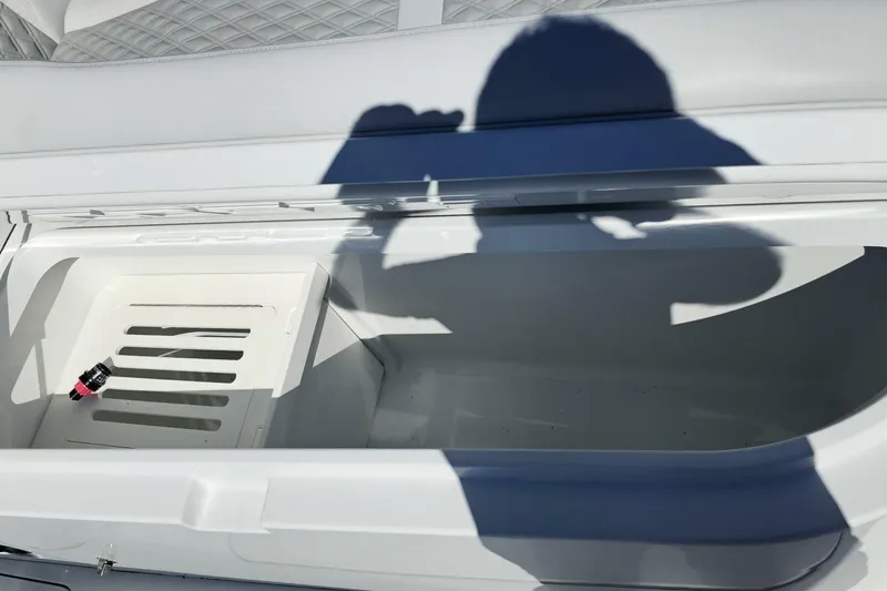  Yacht Photos Pics Open storage compartment on 2025 Costa Custom Boats 34ST, with shadow and small object inside.