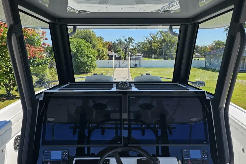  Yacht Photos Pics Interior view of 2025 Costa Custom Boats 34ST cockpit with dual screens and steering wheel.