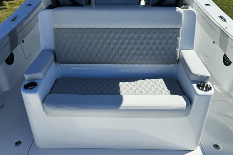  Yacht Photos Pics Luxurious seating on 2025 Costa Custom Boats 34ST, featuring diamond-patterned upholstery and cup holders.