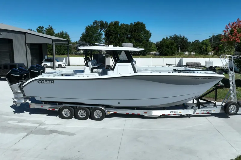  Yacht Photos Pics 2025 Costa Custom Boats 34ST on trailer, parked outdoors under clear blue sky.