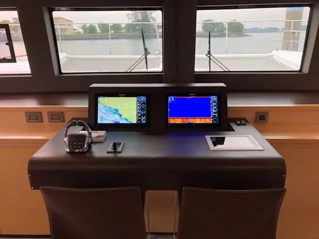  Yacht Photos Pics Control panel of 2017 Lagoon 630 Motor Yacht with navigation screens and headset.