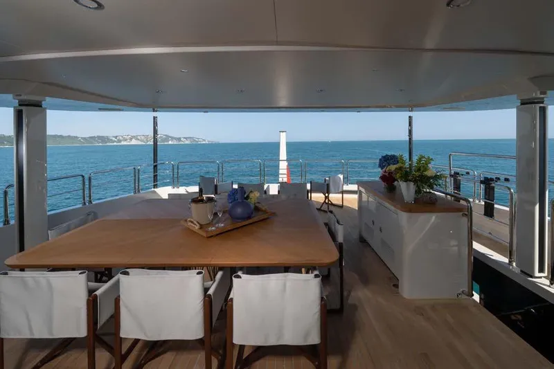 Stellamar Yacht Photos Pics Luxurious 2023 Cantiere Delle Marche RJ 115 yacht deck with ocean view and elegant dining area.