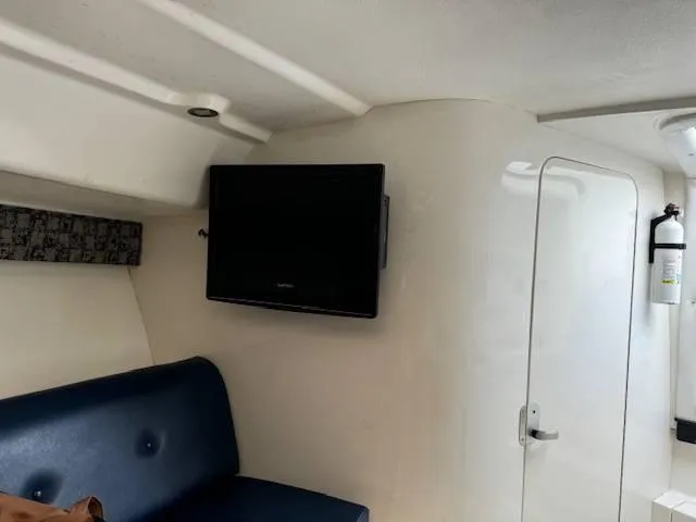 2003 Intrepid 31 Walkaround Yacht Photos Pics Interior of 2003 Intrepid 31 Walkaround with TV and seating area.