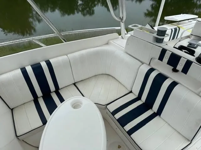 2003 Intrepid 31 Walkaround Yacht Photos Pics 2003 Intrepid 31 Walkaround boat interior with striped seating and table.