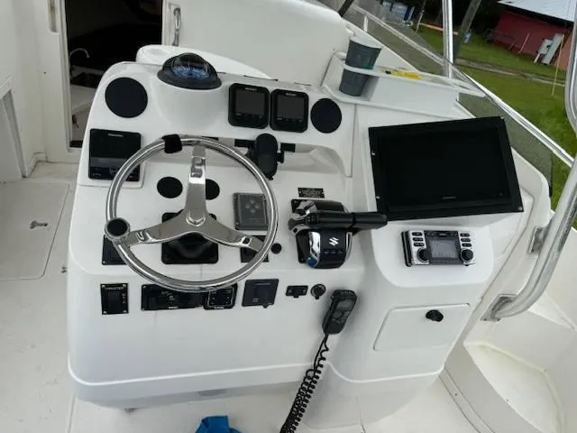 2003 Intrepid 31 Walkaround Yacht Photos Pics 2003 Intrepid 31 Walkaround boat dashboard with steering wheel and navigation controls.