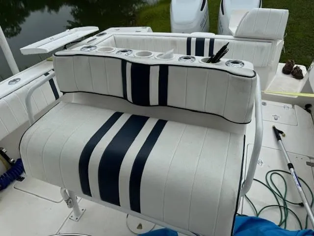 2003 Intrepid 31 Walkaround Yacht Photos Pics 2003 Intrepid 31 Walkaround boat seating with striped upholstery and cup holders.