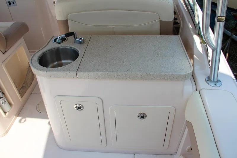 Marleon Yacht Photos Pics 2014 Grady-White Freedom 307 boat interior with sink and storage cabinets.