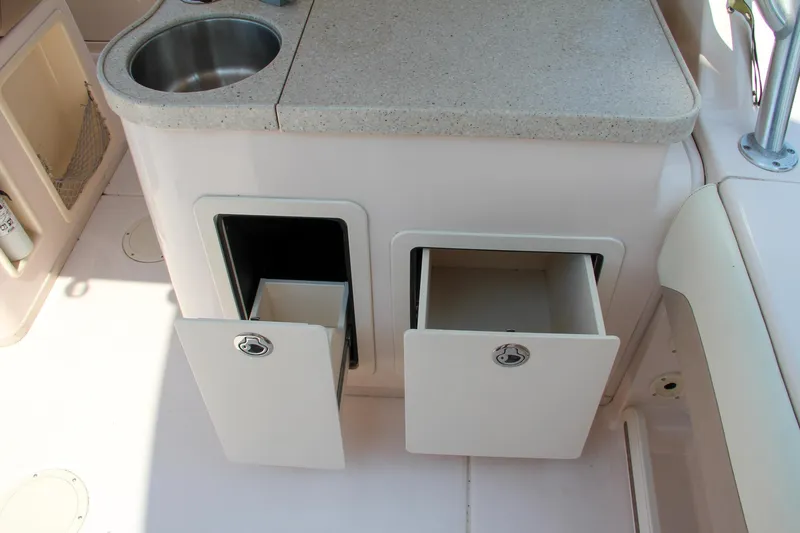 Marleon Yacht Photos Pics 2014 Grady-White Freedom 307 boat interior with sink and storage compartments.