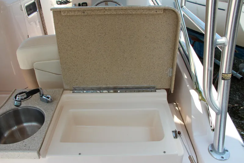Marleon Yacht Photos Pics 2014 Grady-White Freedom 307 boat interior with sink and storage compartment.