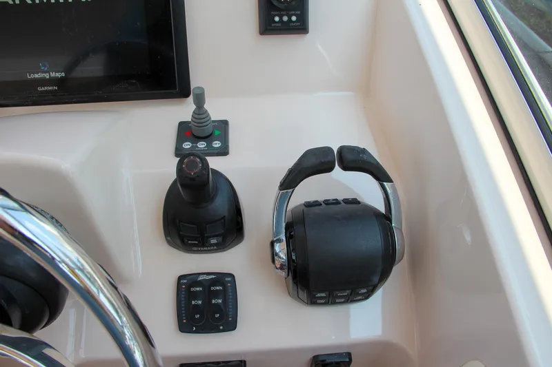 Marleon Yacht Photos Pics Control panel of 2014 Grady-White Freedom 307 boat with steering and throttle controls.