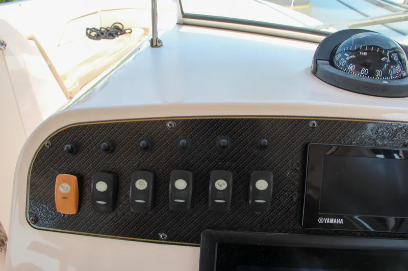Marleon Yacht Photos Pics Dashboard of 2014 Grady-White Freedom 307 boat with control switches and Yamaha display.
