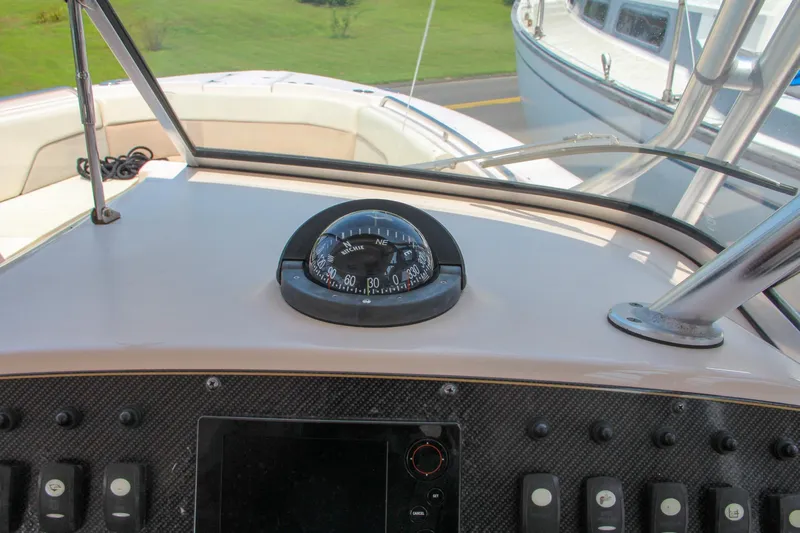 Marleon Yacht Photos Pics Dashboard of a 2014 Grady-White Freedom 307 boat with compass and controls.