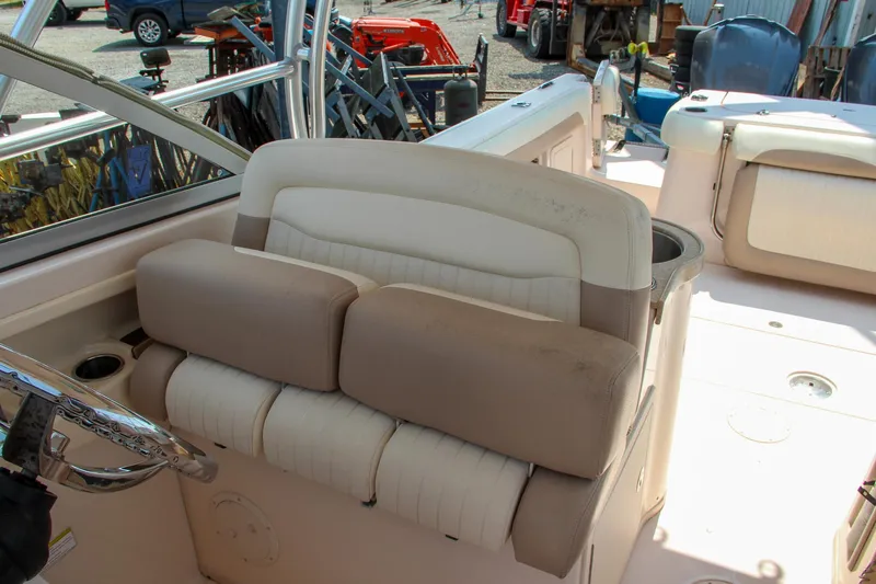 Marleon Yacht Photos Pics 2014 Grady-White Freedom 307 boat interior with cushioned seating and steering wheel.