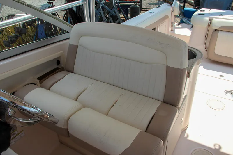 Marleon Yacht Photos Pics 2014 Grady-White Freedom 307 boat interior with beige seating and steering wheel.