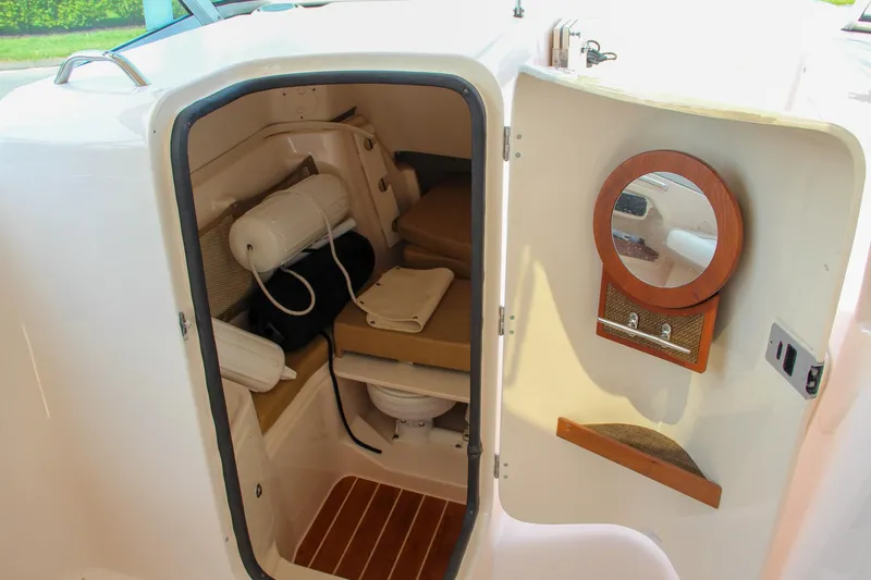 Marleon Yacht Photos Pics 2014 Grady-White Freedom 307 boat cabin interior with seating and mirror.