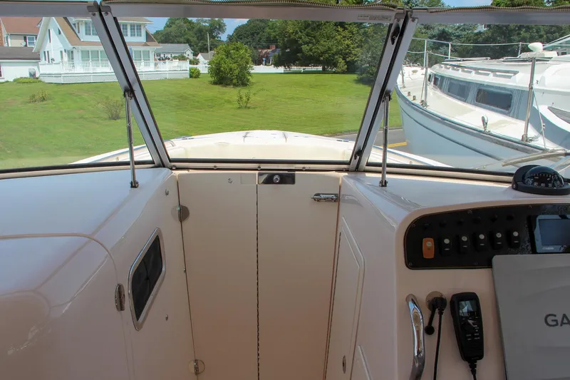 Marleon Yacht Photos Pics 2014 Grady-White Freedom 307 boat interior with control panel and windshield view.