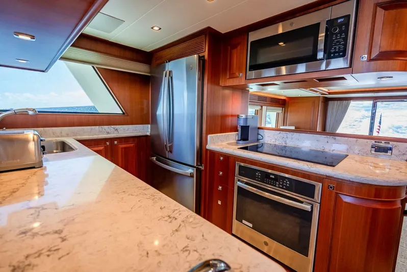 Sunny Seajay Yacht Photos Pics Luxurious kitchen interior of 2022 Hampton 658l Endurance yacht with modern appliances.