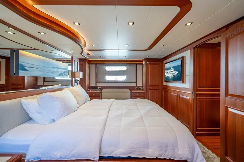 Sunny Seajay Yacht Photos Pics Luxurious bedroom interior of 2022 Hampton 658l Endurance yacht with wood paneling and modern design.