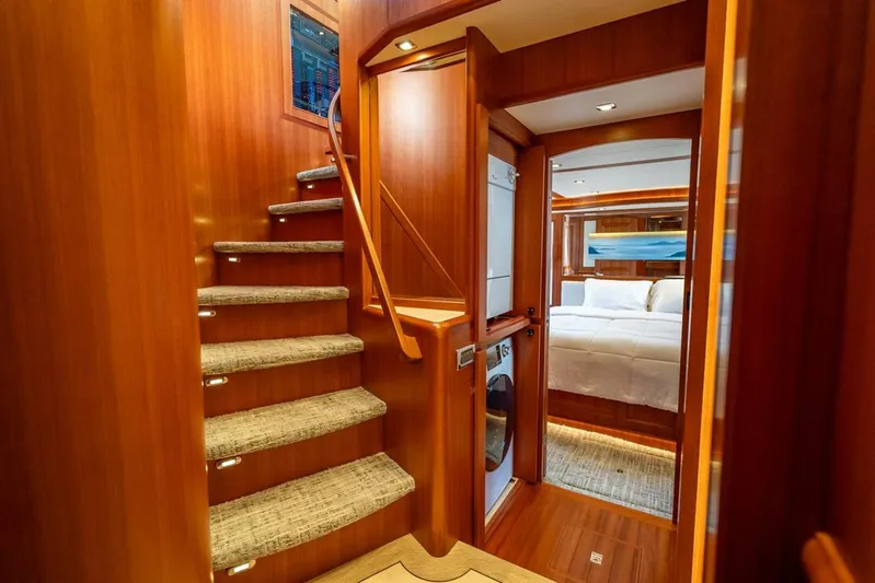 Sunny Seajay Yacht Photos Pics Luxurious interior of 2022 Hampton 658l Endurance yacht with wooden stairs and cozy bedroom.
