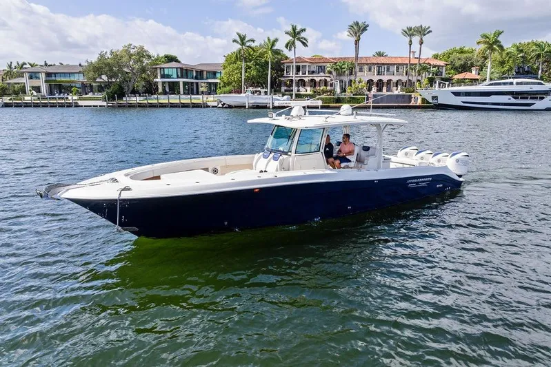 Acevedo Yacht Photos Pics 2016 Hydrosport Siesta boat cruising on a scenic waterfront with luxury homes in the background.