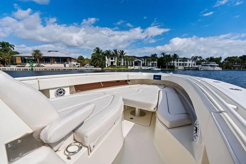 Acevedo Yacht Photos Pics 2016 Hydrosport Siesta boat interior with luxurious seating, docked near waterfront homes.