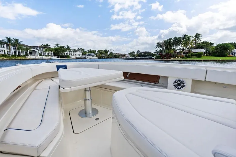 Acevedo Yacht Photos Pics 2016 Hydrosport Siesta boat interior with white seating, on a scenic waterfront.