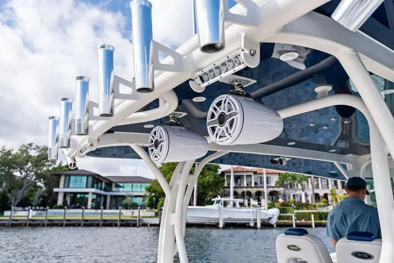 Acevedo Yacht Photos Pics 2016 Hydrosport Siesta boat with speakers and rod holders, docked near waterfront homes.