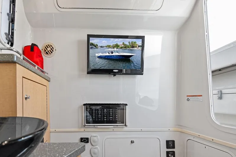 Acevedo Yacht Photos Pics Interior of a 2016 Hydrosport Siesta boat with TV and control panel.