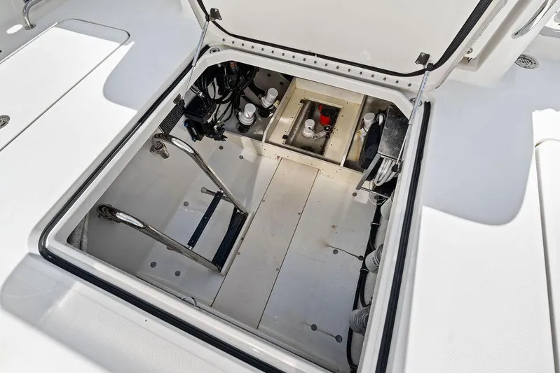 Acevedo Yacht Photos Pics Open hatch of 2016 Hydrosport Siesta boat showing interior components and storage.