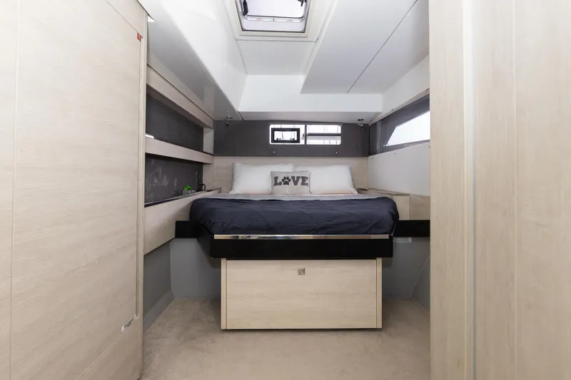  Yacht Photos Pics Modern bedroom interior in a 2021 Leopard 50 yacht, featuring a cozy bed and sleek design.