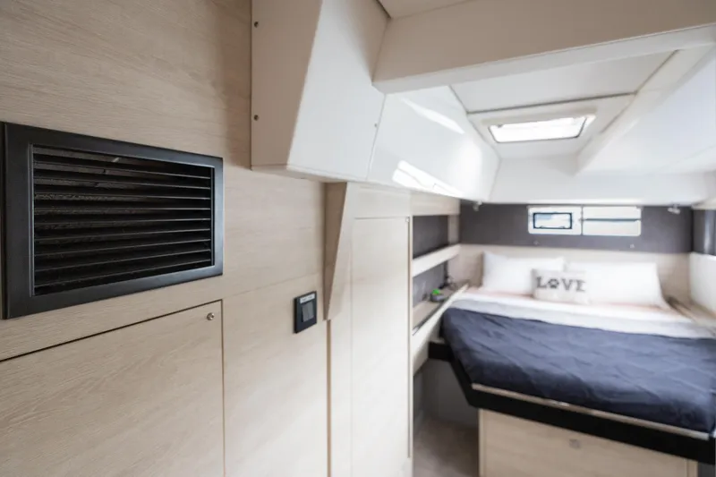  Yacht Photos Pics Modern interior of 2021 Leopard 50 yacht cabin with bed and ventilation.