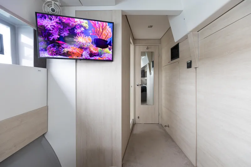  Yacht Photos Pics Modern yacht interior with wall-mounted TV displaying vibrant coral reef, Leopard 50, 2021 model.
