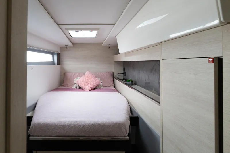  Yacht Photos Pics Cozy bedroom interior in a 2021 Leopard 50 yacht, featuring a skylight and modern design.