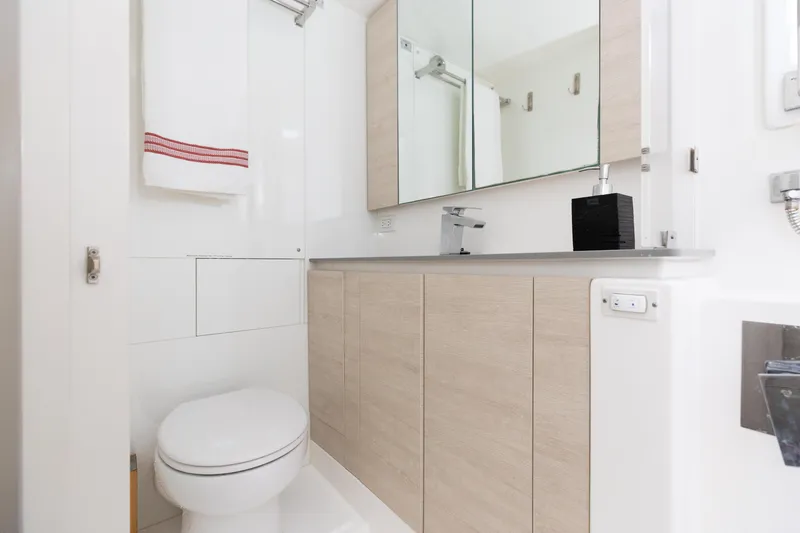  Yacht Photos Pics Modern bathroom in Leopard 50 yacht, featuring sleek cabinetry and mirrored storage.