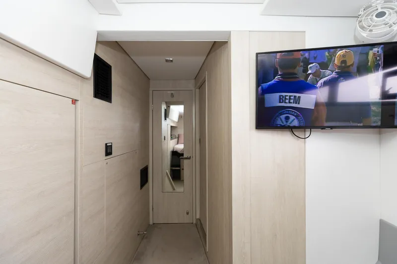  Yacht Photos Pics Modern interior of 2021 Leopard 50 yacht with hallway and wall-mounted TV.