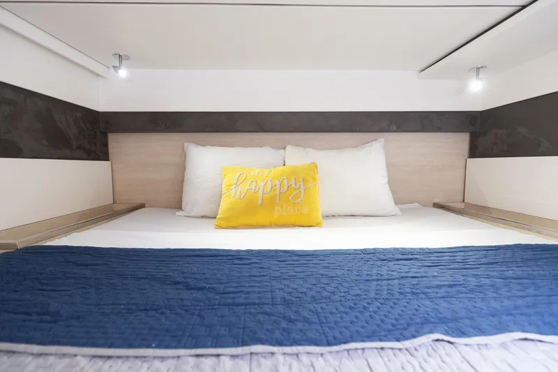  Yacht Photos Pics Cozy bed in Leopard 50 yacht with blue blanket and yellow "happy place" pillow.