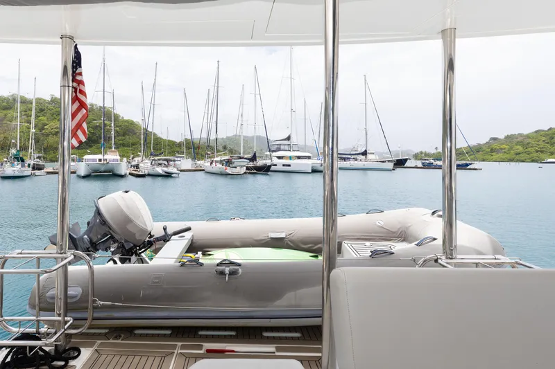  Yacht Photos Pics Leopard 50 yacht deck with dinghy, overlooking marina with sailboats, 2021 model.