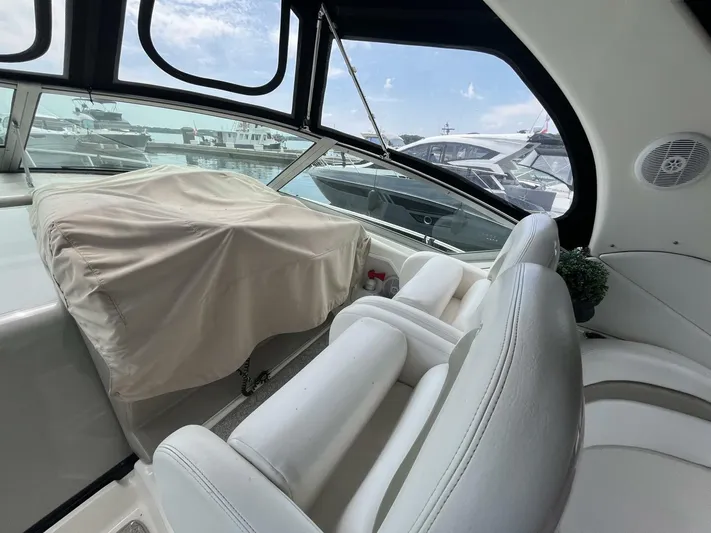  Yacht Photos Pics 2007 Sea Ray 340 Sundancer interior with white seating and covered dashboard.