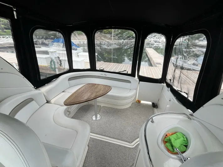  Yacht Photos Pics Interior of 2007 Sea Ray 340 Sundancer with white seating and wooden table.