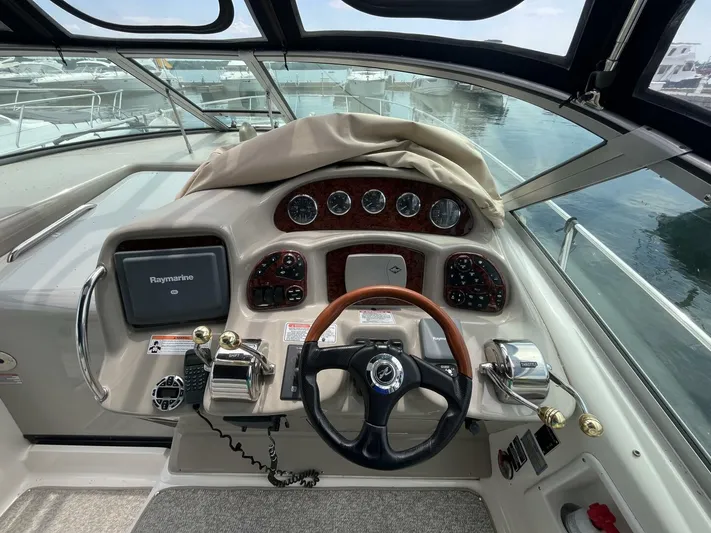  Yacht Photos Pics 2007 Sea Ray 340 Sundancer helm with steering wheel, gauges, and navigation equipment.