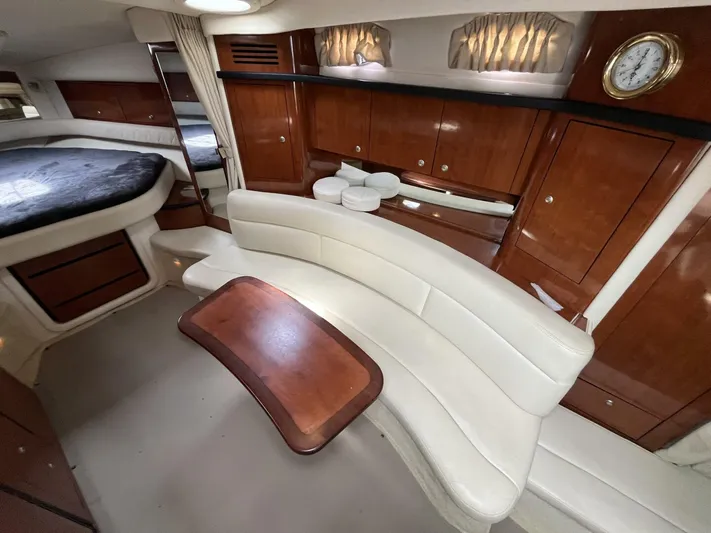  Yacht Photos Pics Luxurious interior of 2007 Sea Ray 340 Sundancer with elegant seating and wooden cabinetry.