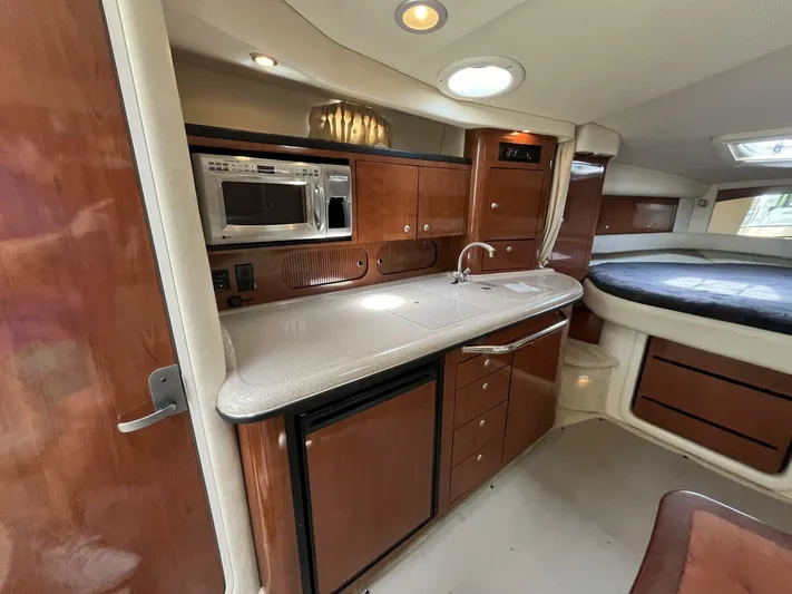  Yacht Photos Pics Interior of 2007 Sea Ray 340 Sundancer with kitchenette and sleeping area.