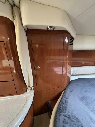  Yacht Photos Pics 2007 Sea Ray 340 Sundancer cabin interior with wood cabinetry and bed.