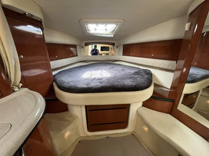  Yacht Photos Pics Luxurious cabin interior of 2007 Sea Ray 340 Sundancer with plush bedding and wood accents.