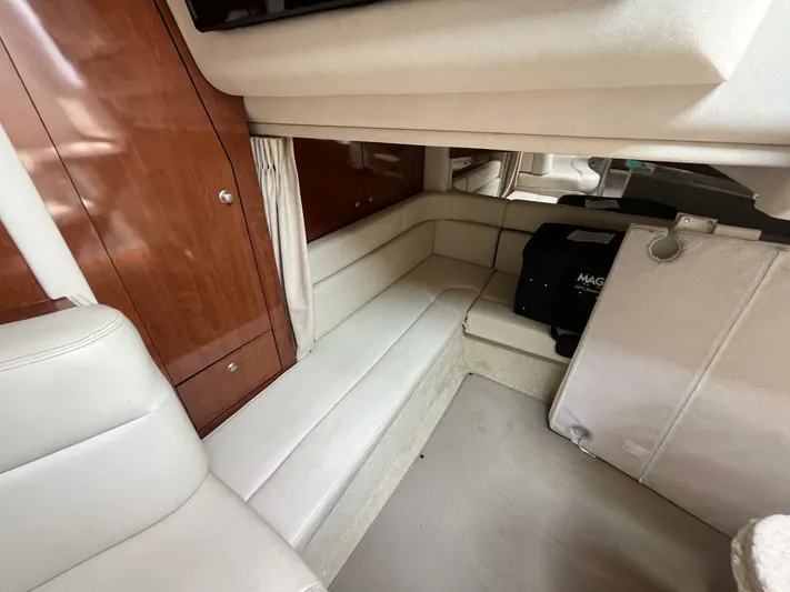  Yacht Photos Pics Interior of 2007 Sea Ray 340 Sundancer with white seating and wooden cabinetry.