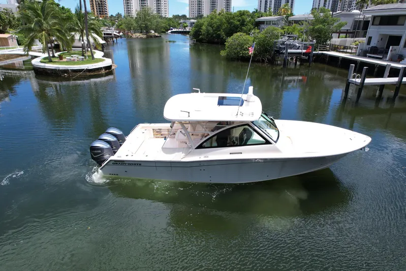 37 Grady White Freedom Yacht Photos Pics 2017 Grady-White Freedom 375 boat cruising on a scenic waterway with lush greenery.